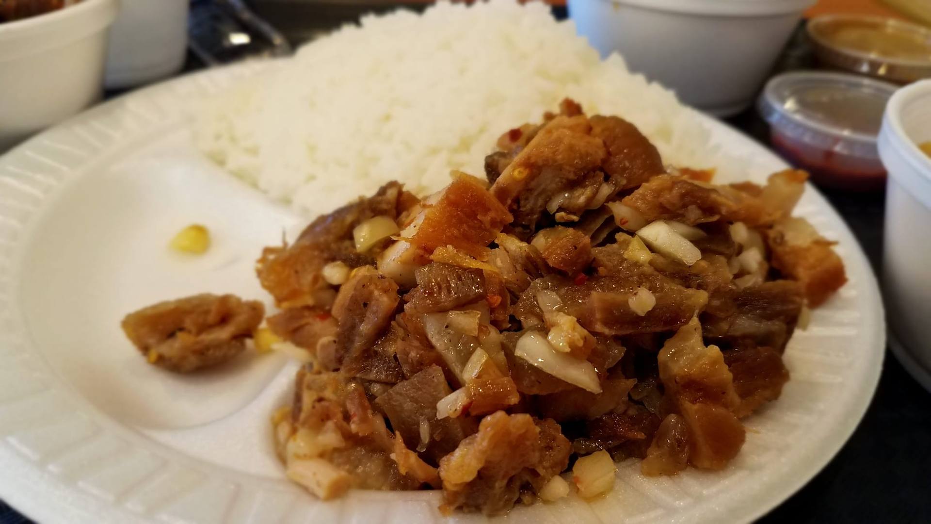Sizzling pork sisig served in a cast-iron skillet
