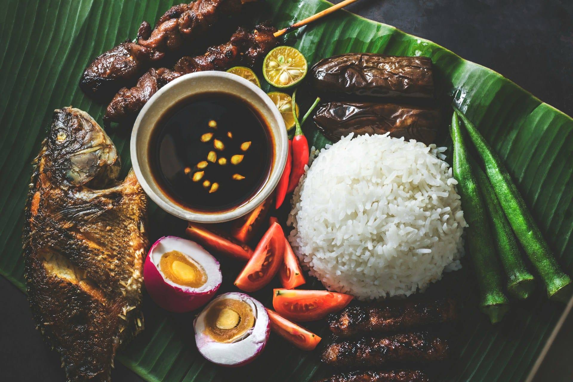 Variety of fried Filipino dishes served on a banana leaf