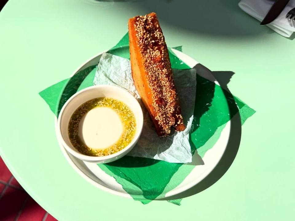 Sesame-crusted fried toast with dipping sauce on a mint-green table, Boodle Fight Stirchley