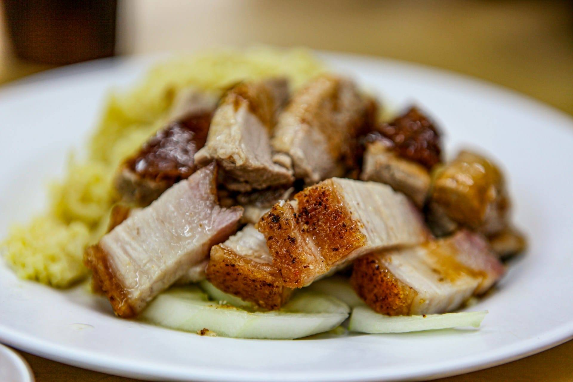 Crispy roasted pork belly with golden crackling, sliced and served