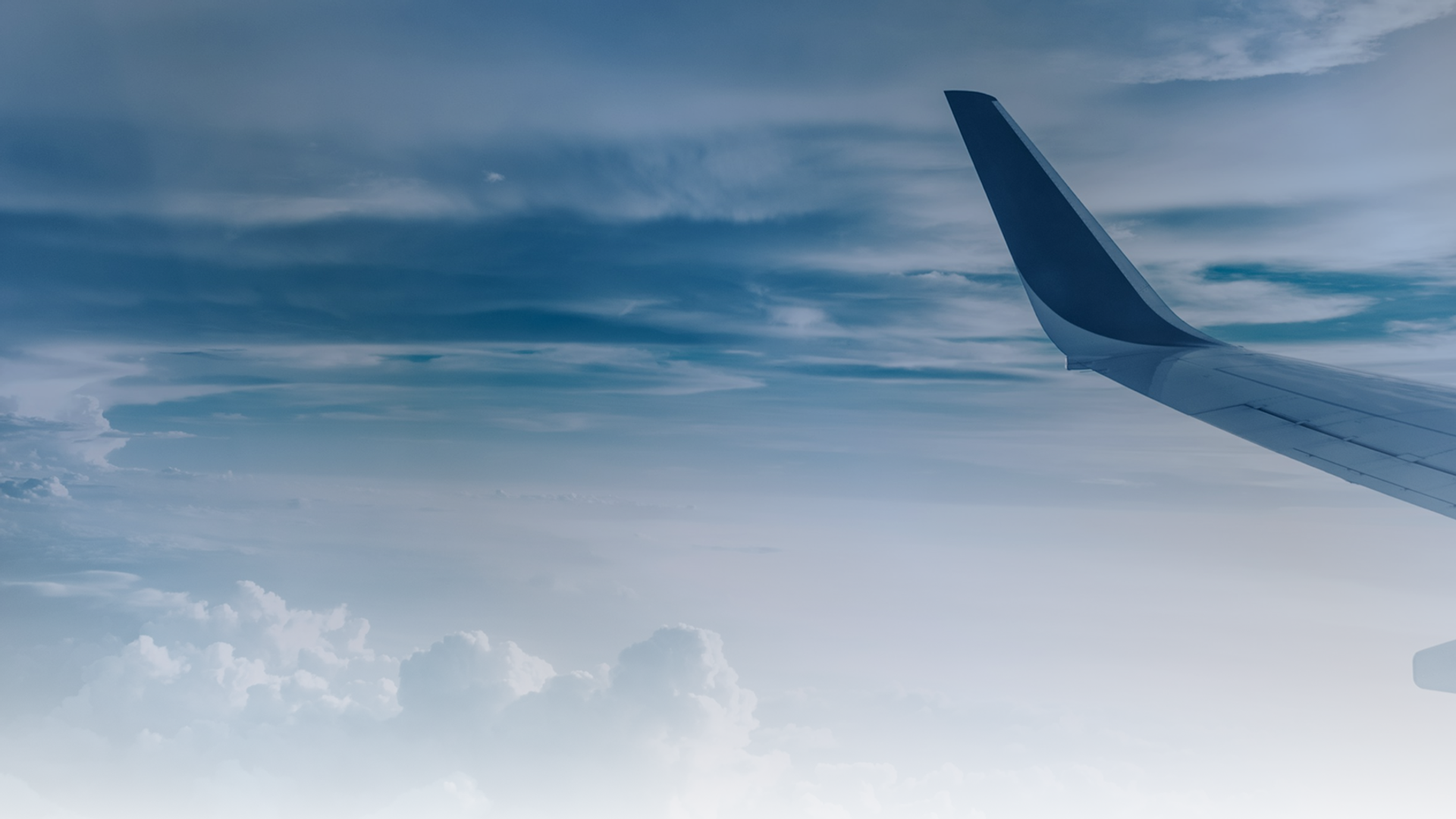 Airplane wing view from aircraft window — Courses page hero