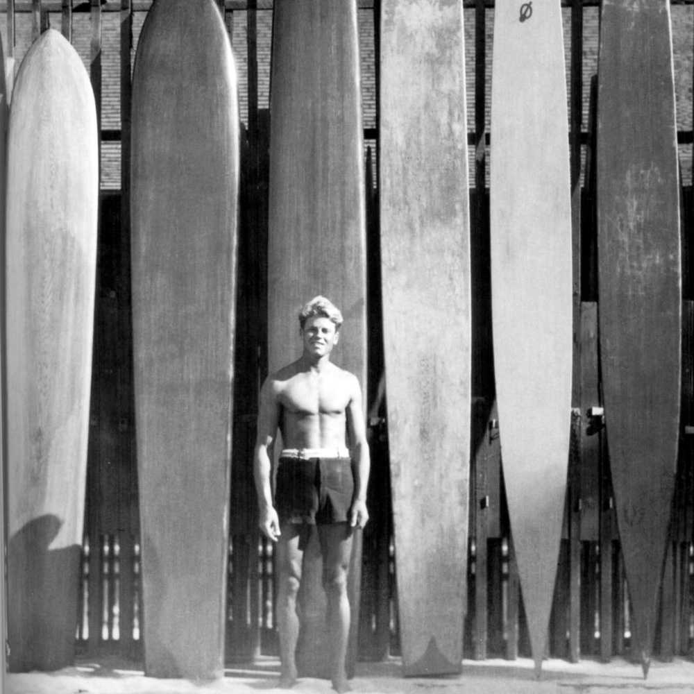 surfer and surfboard designer tom blake in waikiki with surfboards