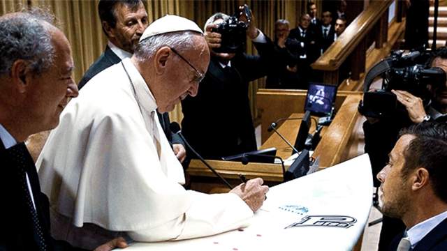Pope Francis signs a surfboard, the Vatican, 2016