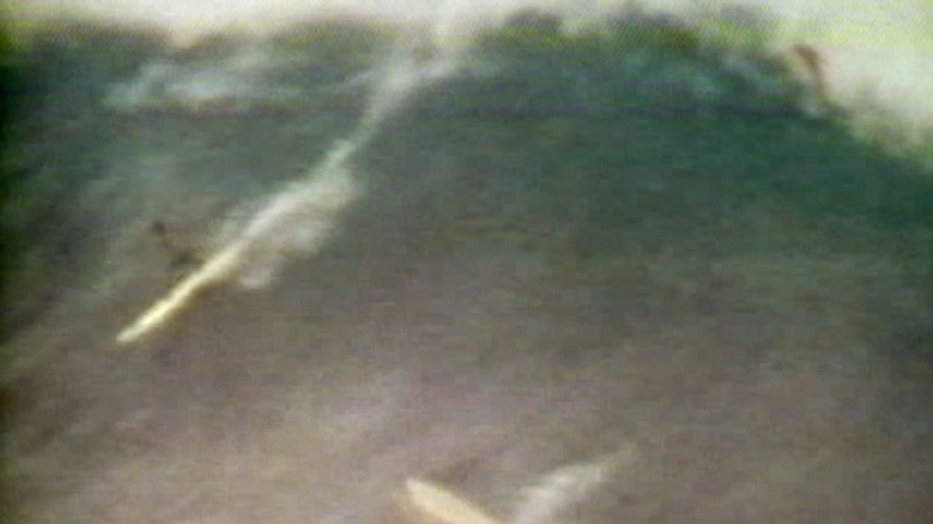 Michael Ho surfing at Waimea Bay.