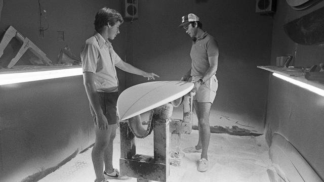 Al Merrick, right, shaping a channel bottom board for Tom Curren, around 1982