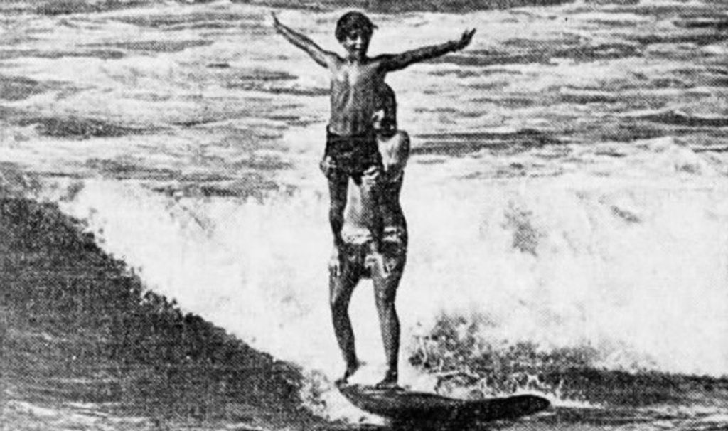 Michael Ho surfing tandem at 1969 Makaha International Surfing Championships.