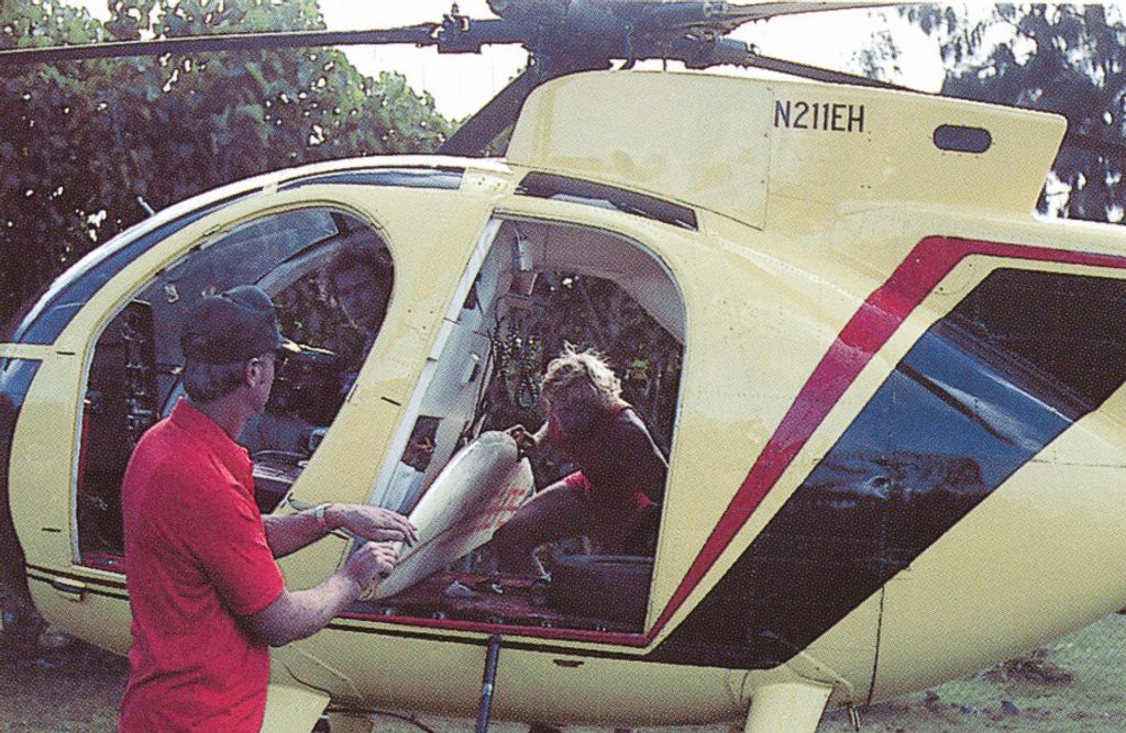 Alec Cooke, aka Ace Cool, loads his board into a helicopter