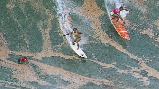 Dennis Pang (left) and Marvin Foster, Waimea, 1988. Photo: Art Brewer