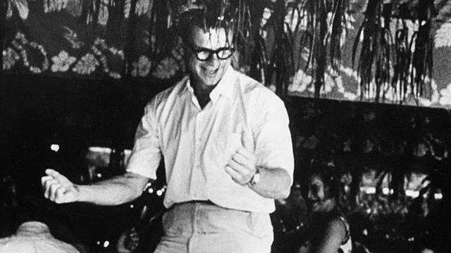 Eugene Burdick, table-dancing in Tahiti, 1962