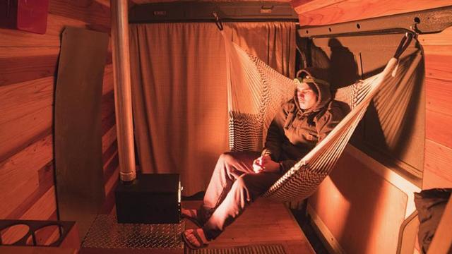 Cyrus Sutton warming up in his stove-equipped van