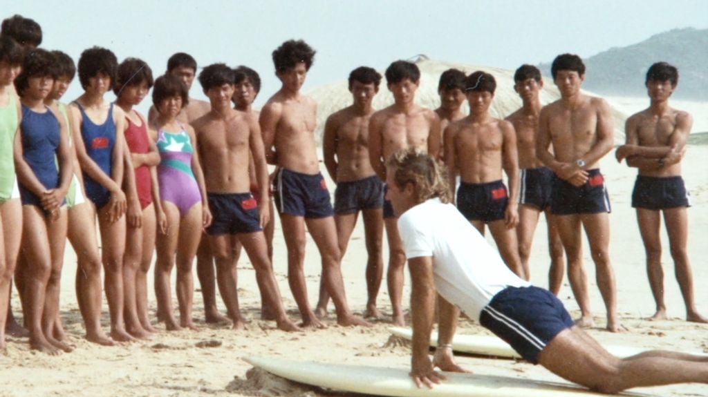 peter drouyn giving a surfing lesson in china in 1985