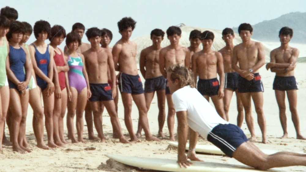 peter drouyn giving a surfing lesson in china in 1985