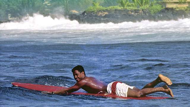 Eddie Aikau paddles into the lineup at Waimea Bay. Photo: Don James