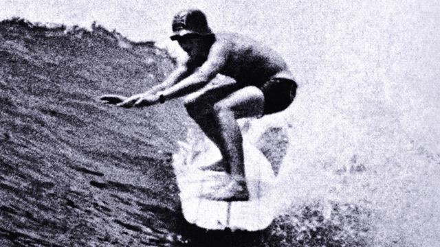 Surfer wearing plastic German army helmet, 1966