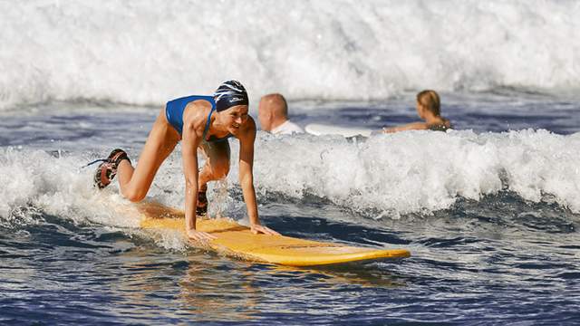 Beginning surfer on a reform wave
