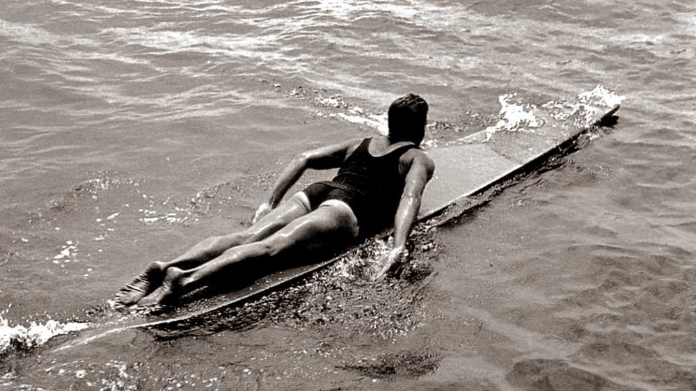 tom blake on a hollow paddleboard