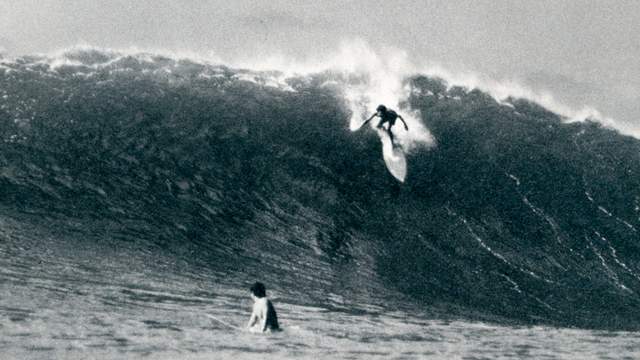Michael Ho on a Dick Brewer surfboard, Waimea, 1975. Photo: Dan Merkel