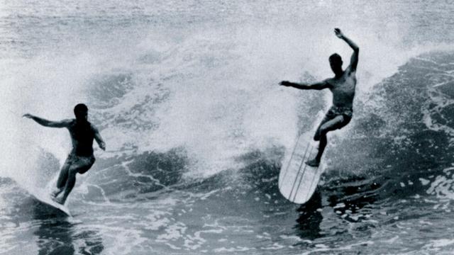 Mike Diffenderfer (left) and Phil Edwards ride backside at Cottons Point, around 1960. Photo: Bruce Brown