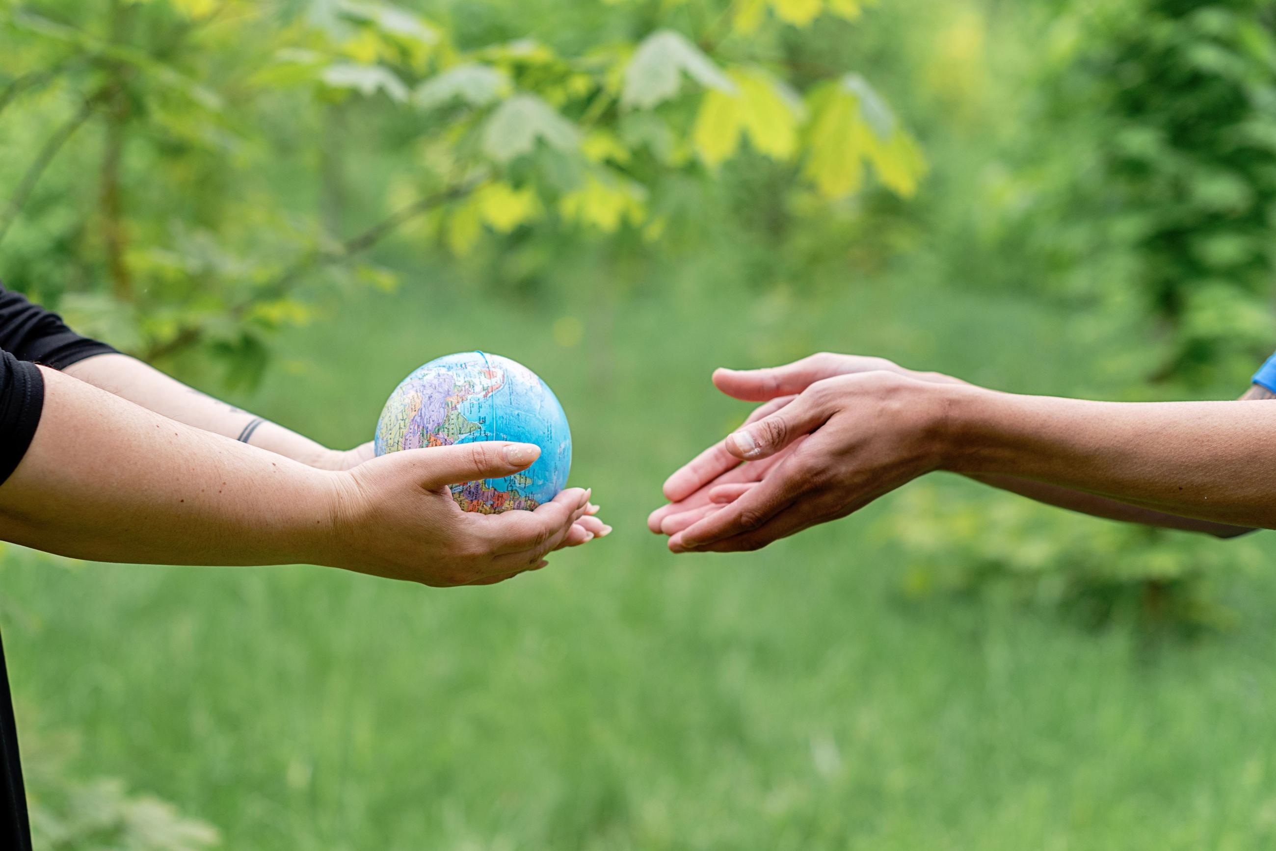 Hands holding a globe