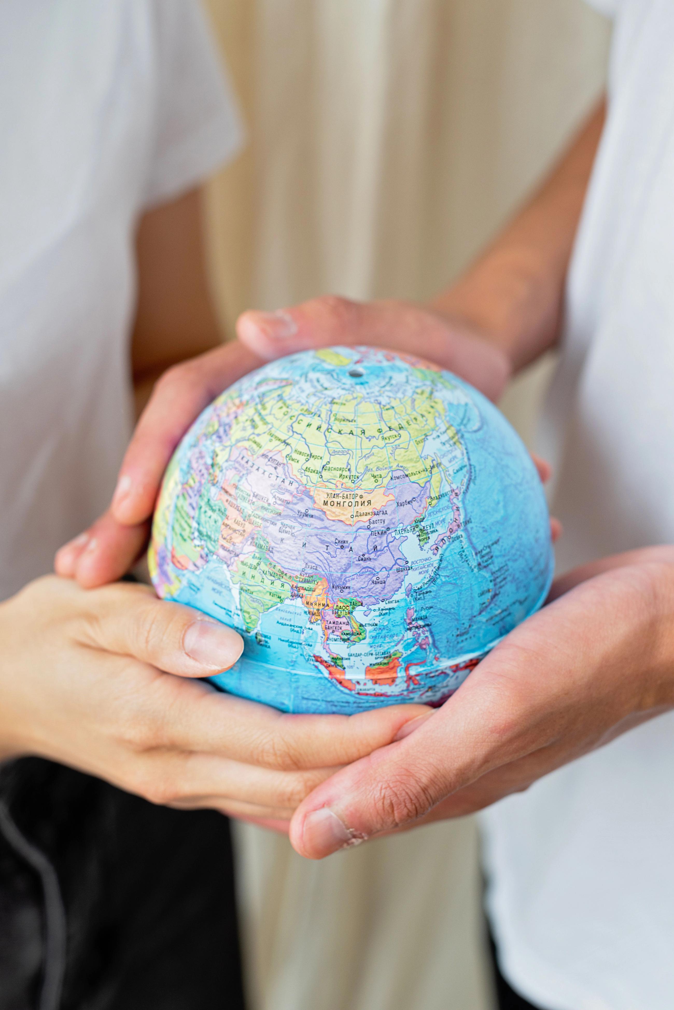 Hands holding a globe
