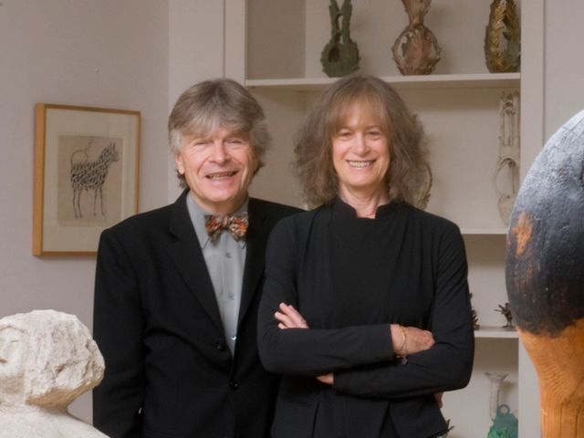 Donors Jill and Sheldon Bonovitz smiling for a portrait in a gallery