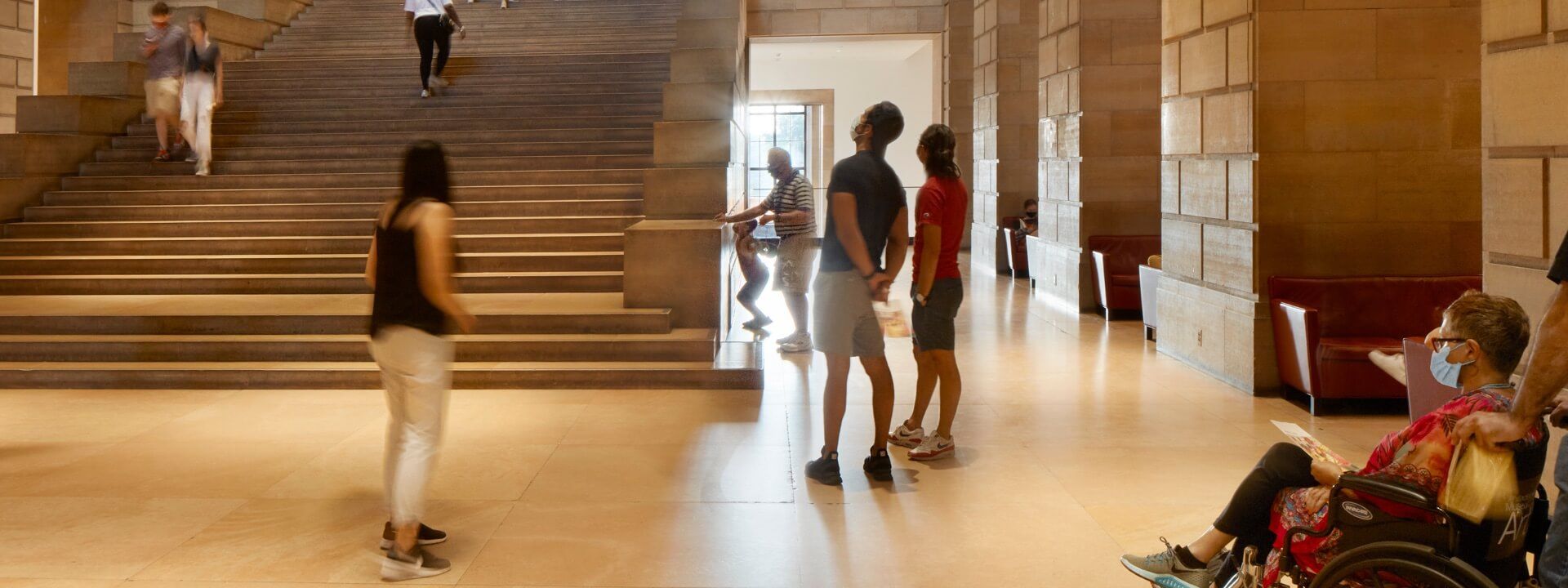 Masked visitors in the museum's Great Stair Hall