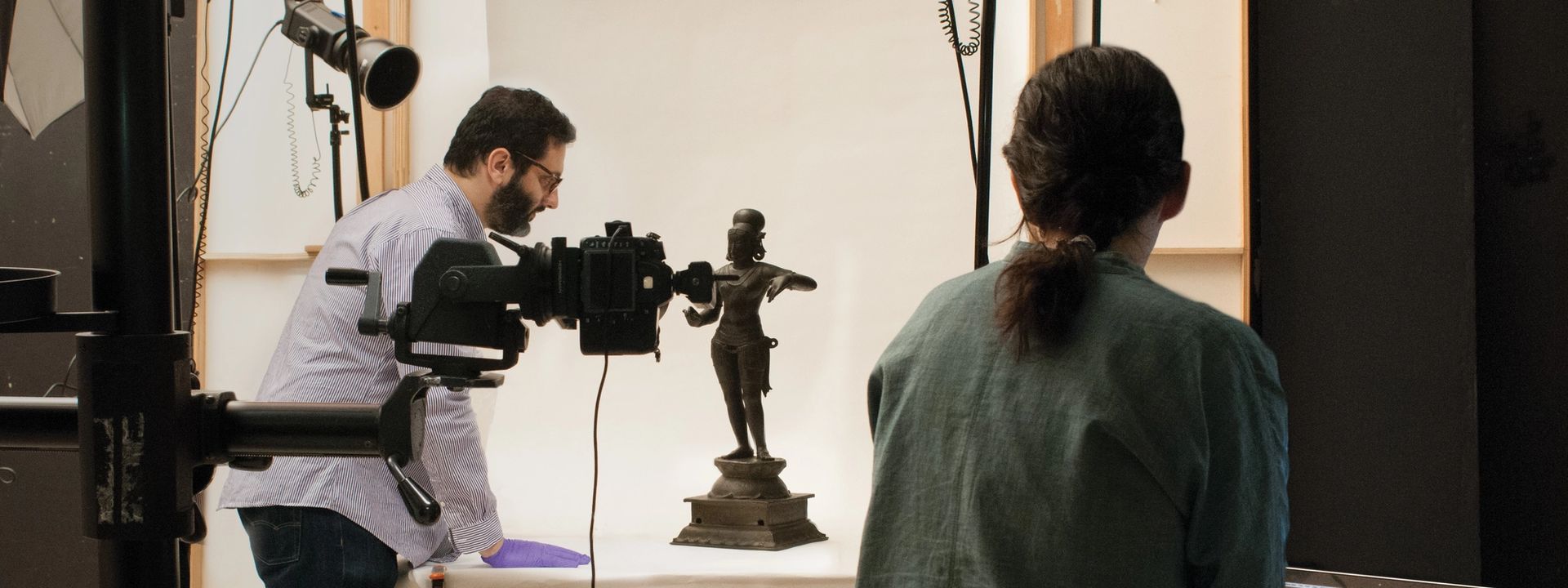 Two photographers in the photo studio taking images of a sculpture