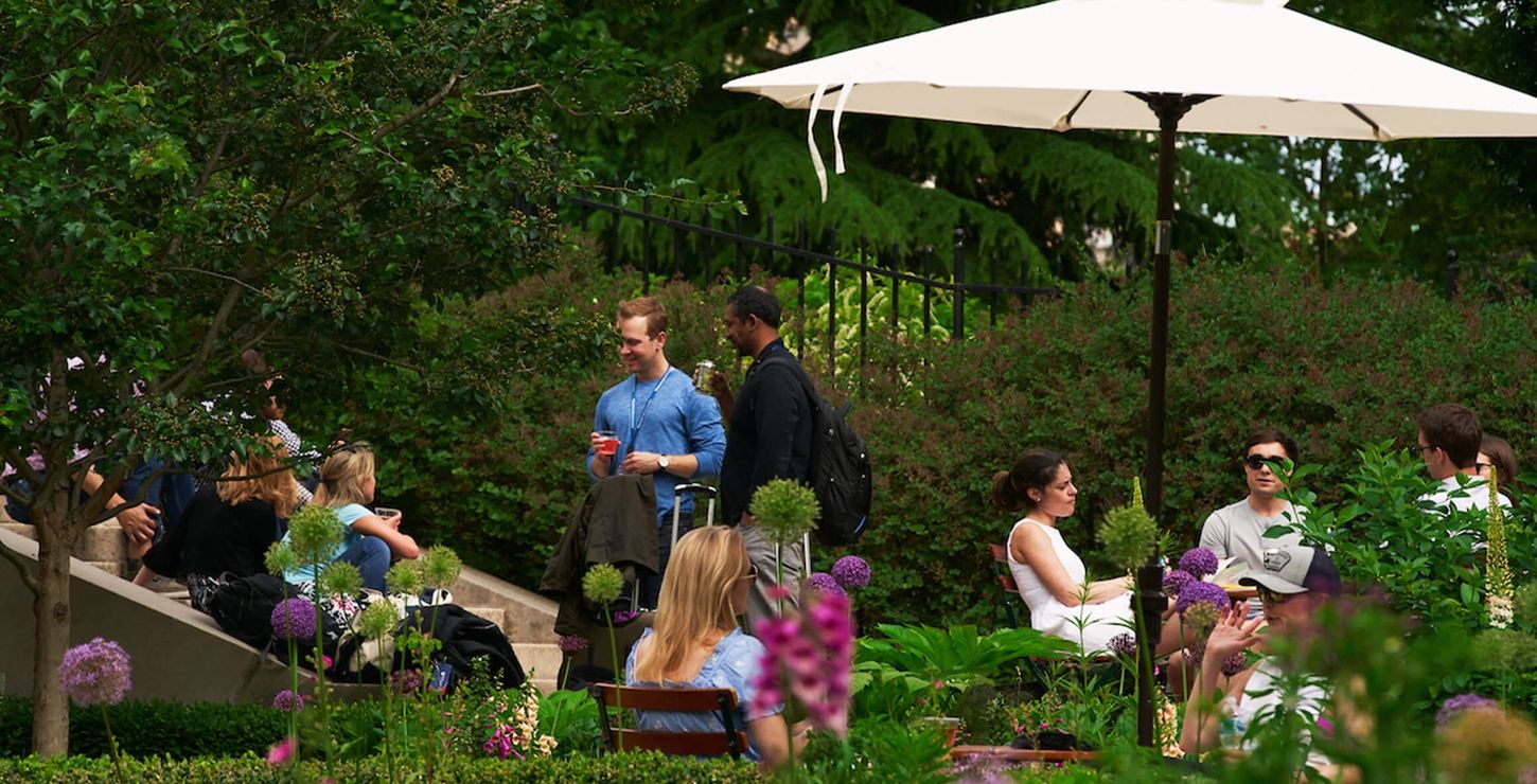 Visitors talking and drinking outside at the Garden Bar