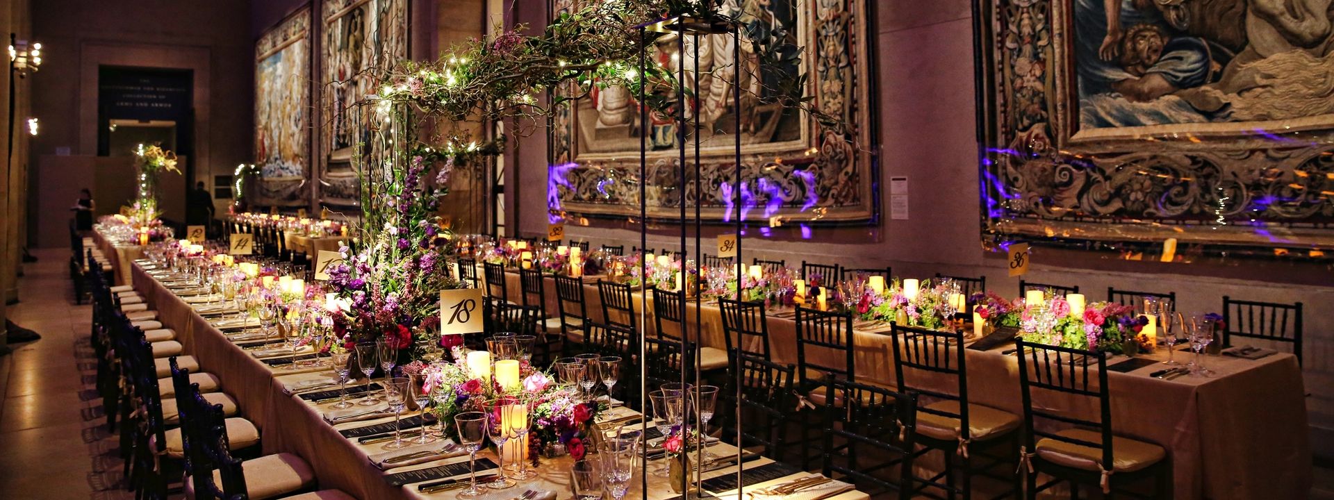Long tables decorated with candles and colorful flowers for a wedding reception on the east balcony in the main building