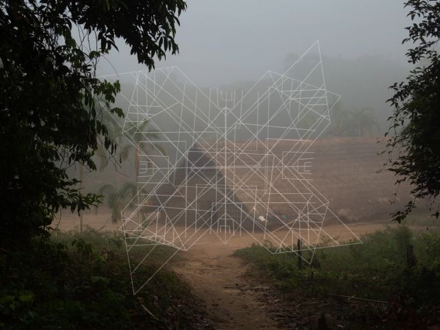 A photo of a longhouse in the river Piraparaná, overlaid with an intricate geometric white pattern.