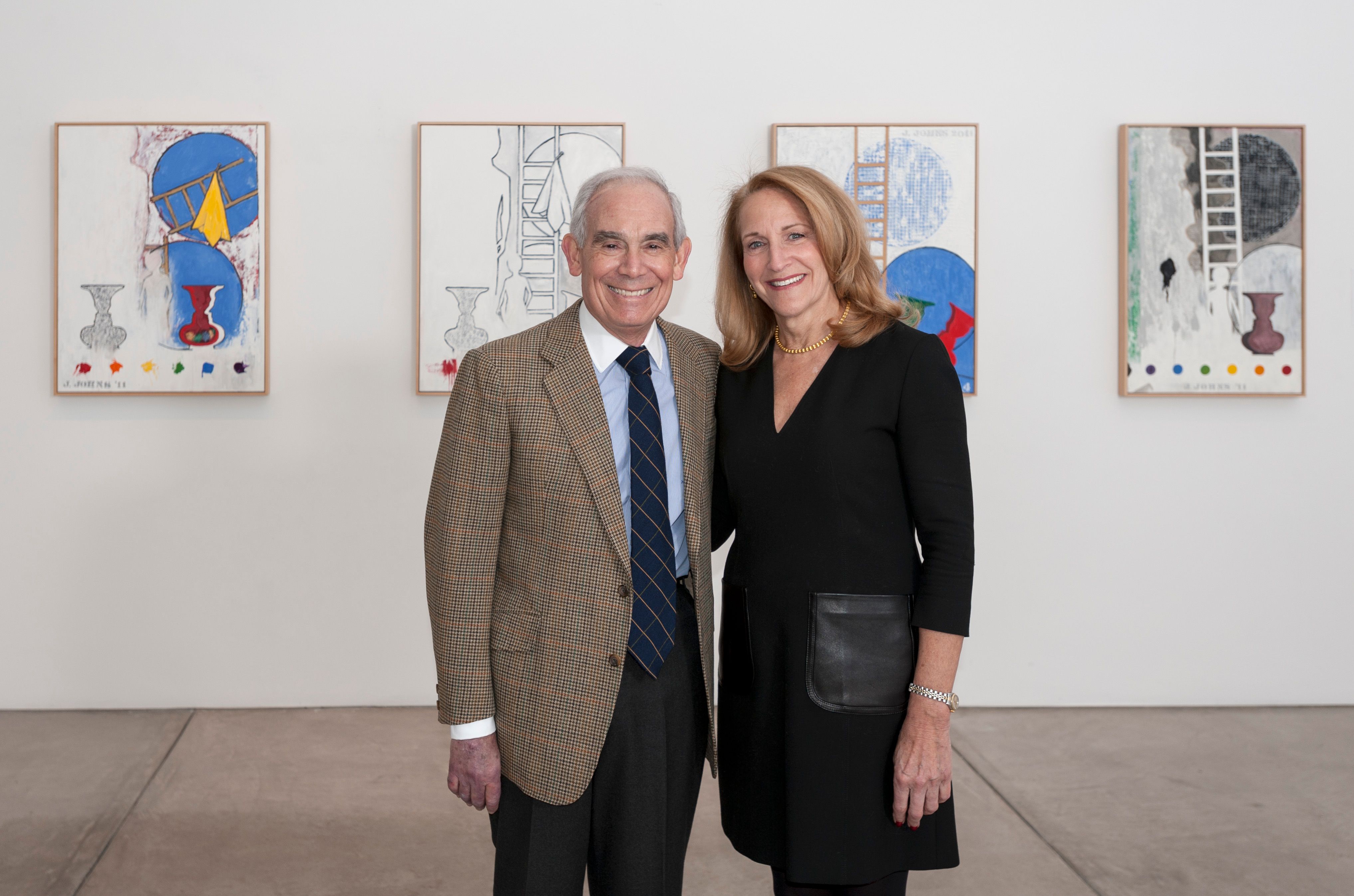Donors Keith L. and Katherine Sachs standing in front of artworks in a gallery