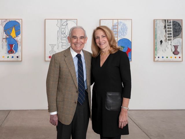Donors Keith L. and Katherine Sachs standing in front of artworks in a gallery