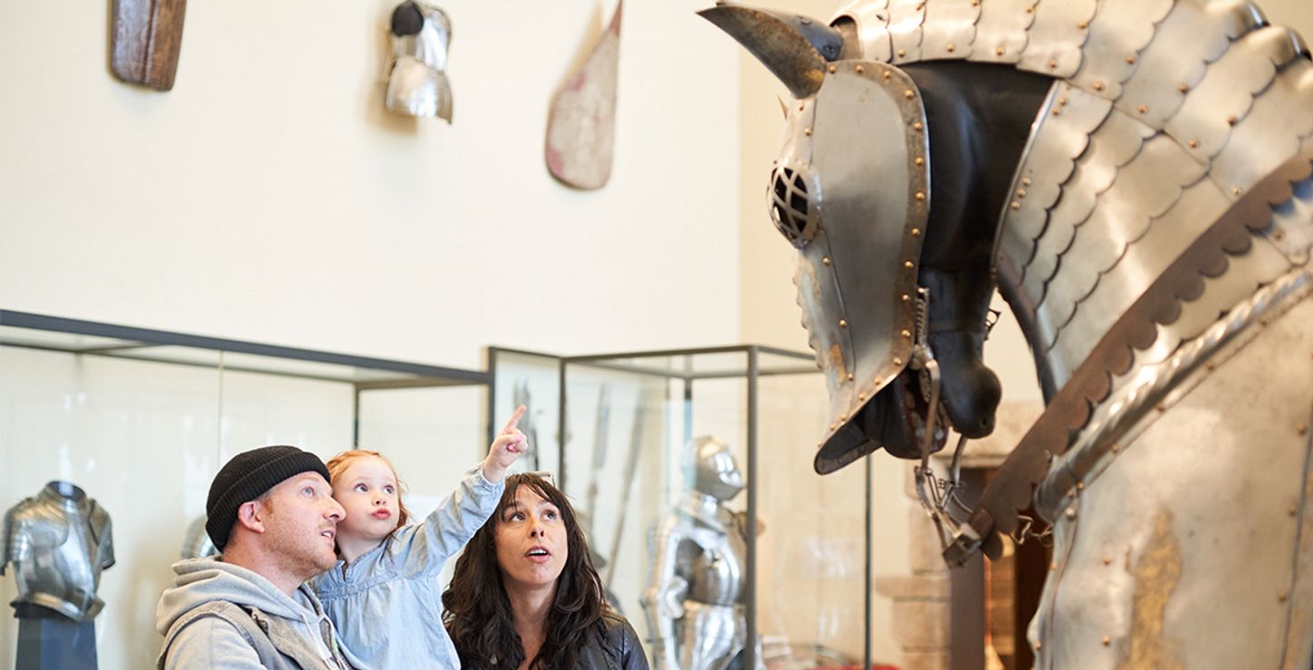Family exploring the arms and armor galleries