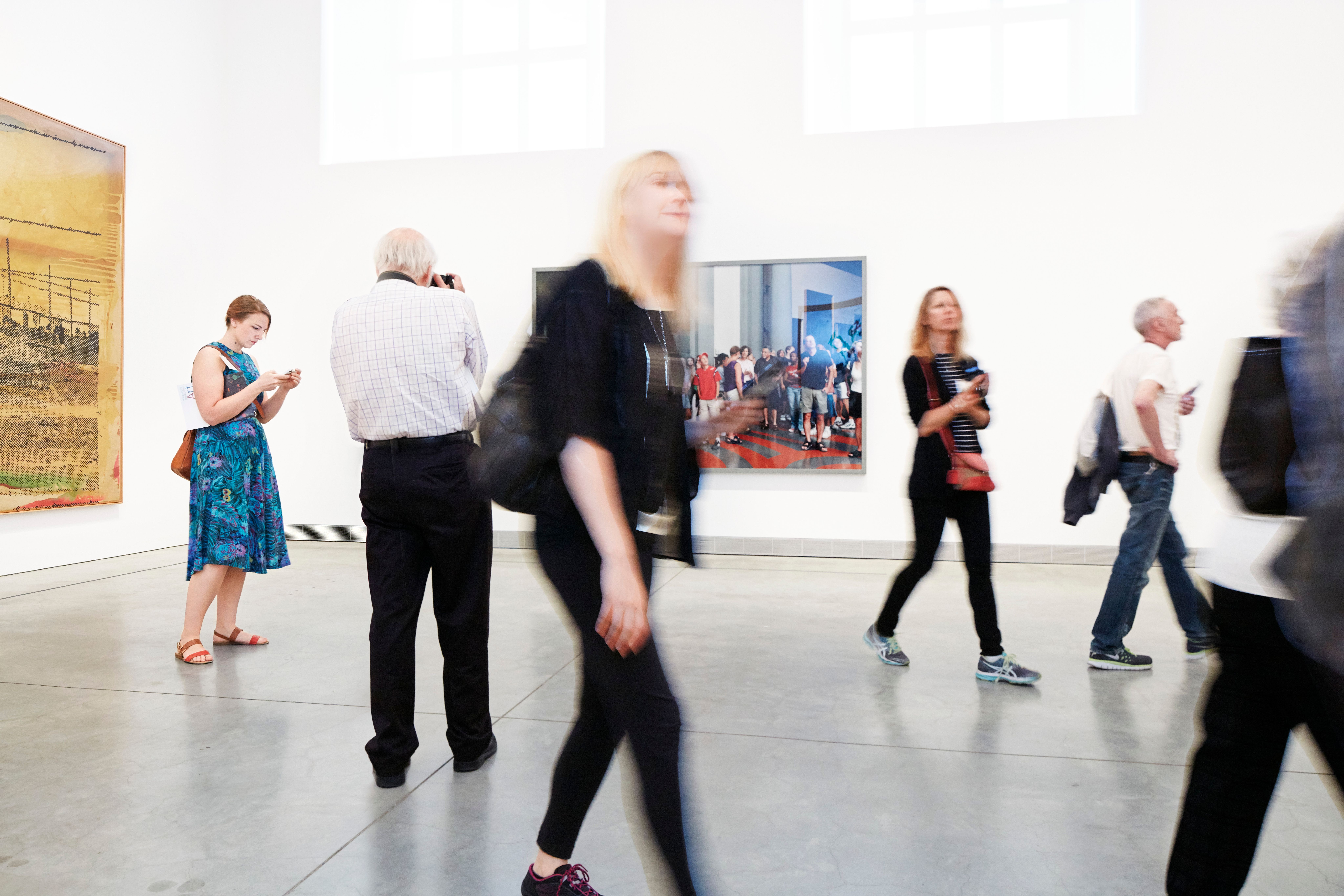 Visitors walking through a museum gallery