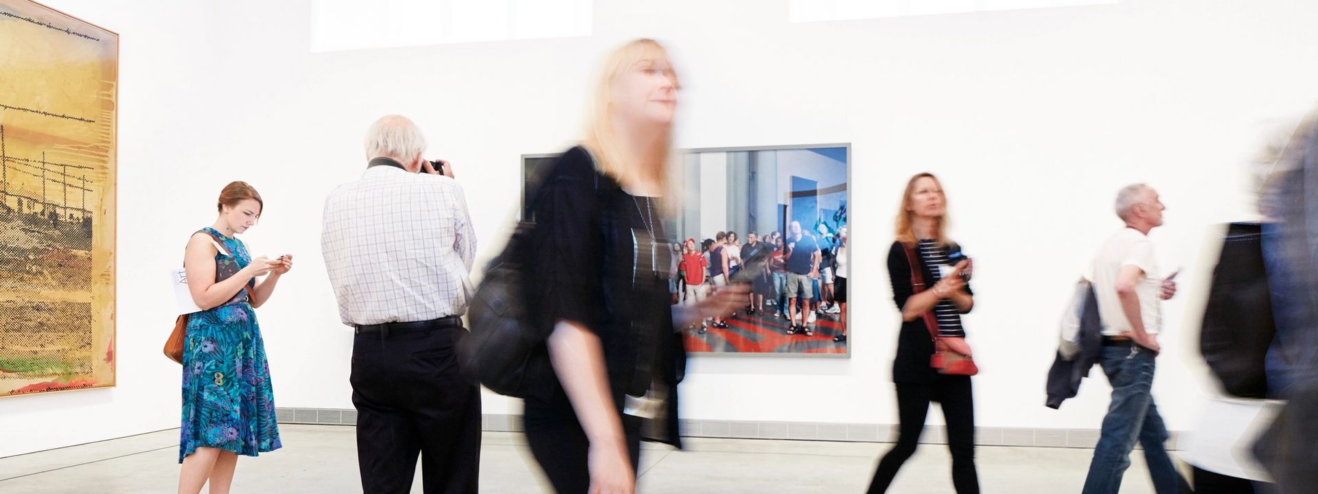 Visitors walking through a museum gallery