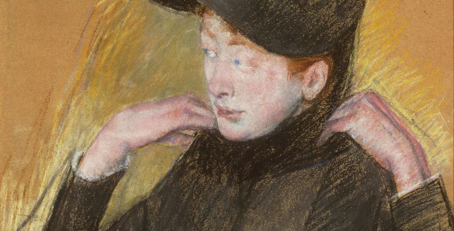 A woman dressed in a black dress and arranging her veil.