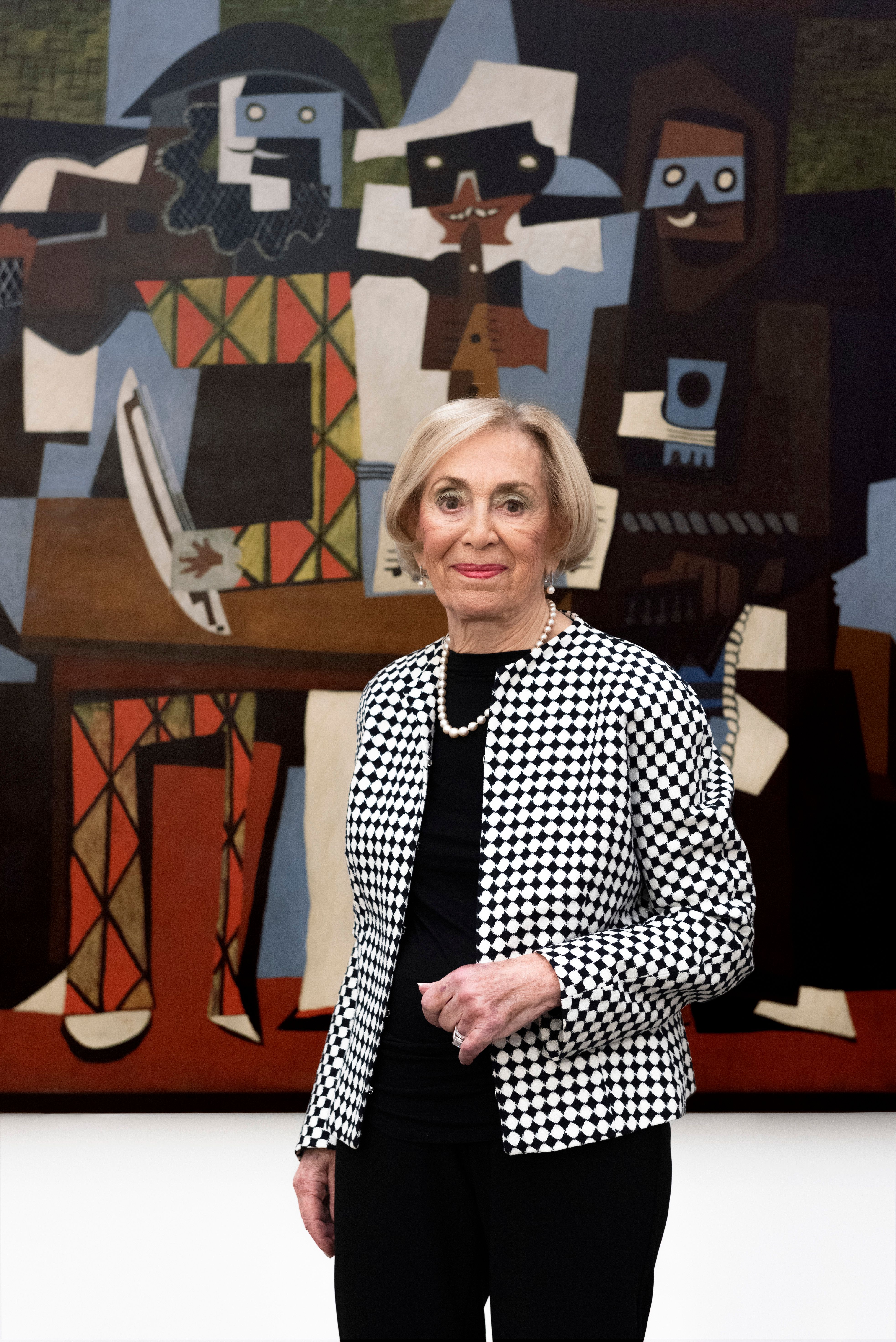 Donor Sonia Triester standing in front of Three Musicians by Pablo Ruiz y Picasso