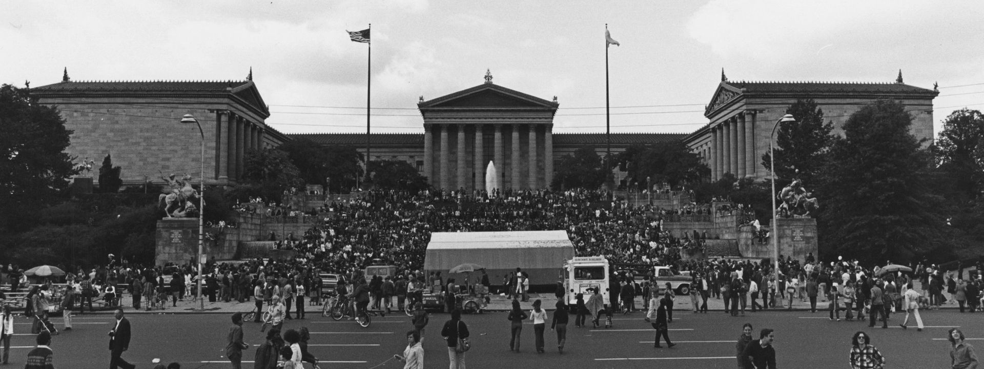 Black and white photograph of a crowd of people on the museum's Rocky steps