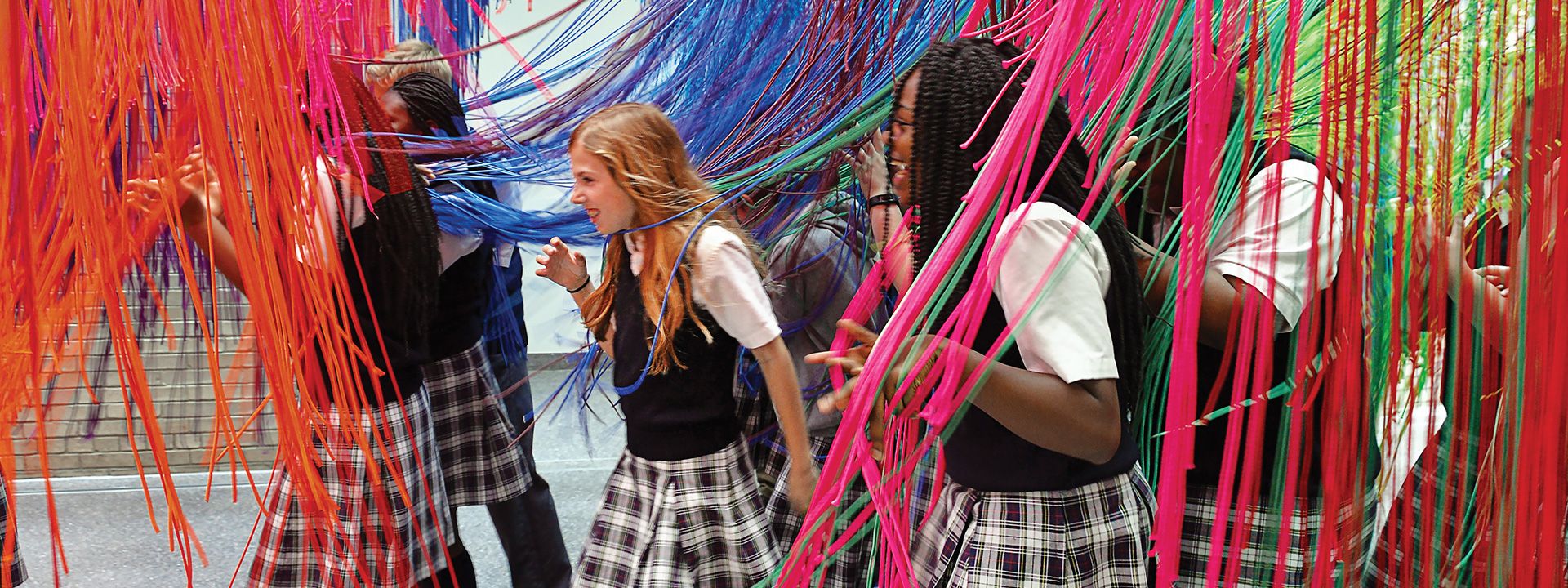 School group interacting with an art installation
