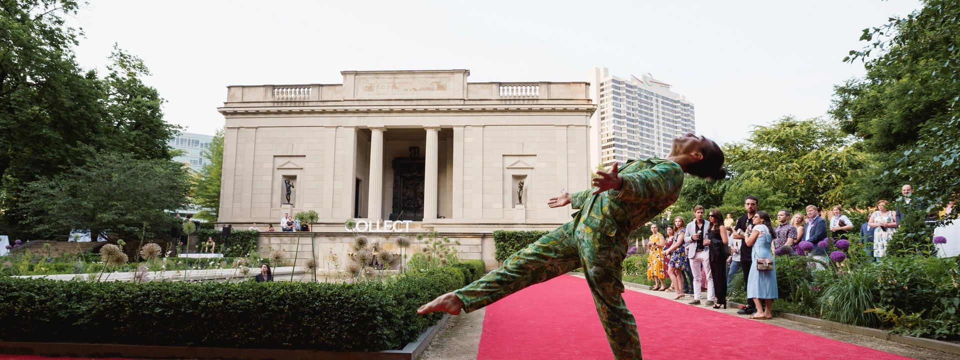 Performer dancing outside the Rodin Museum during a Collect members event