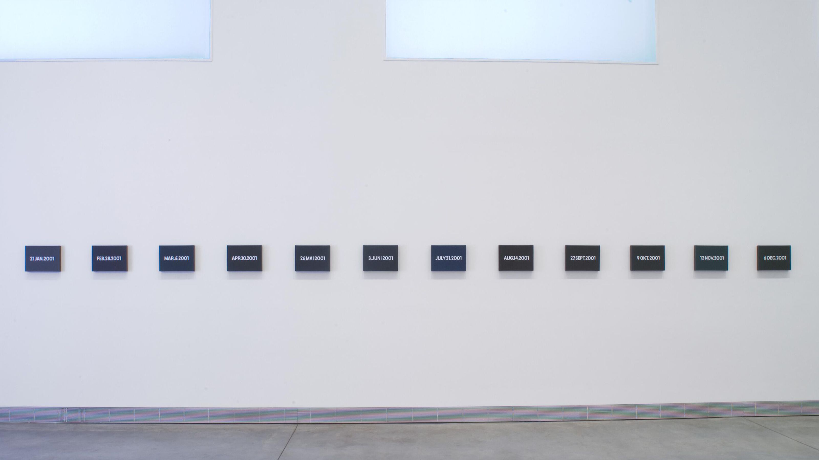 A painting series of twelve canvases that show a unique date for each month in the year 2001.