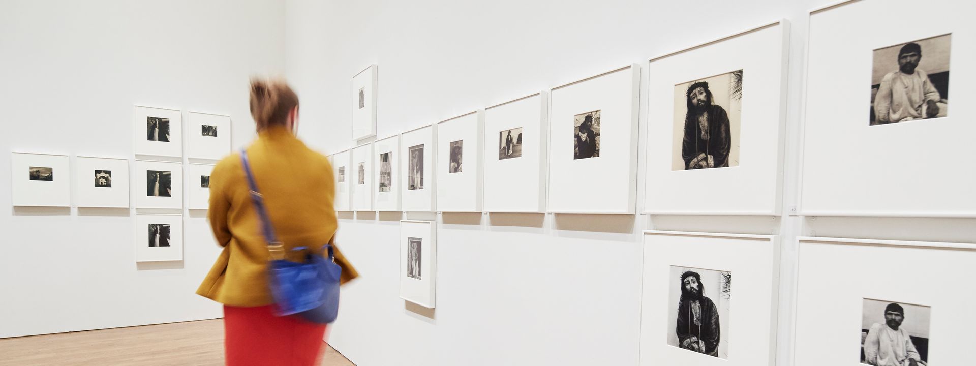 A visitor in motion walking through a gallery