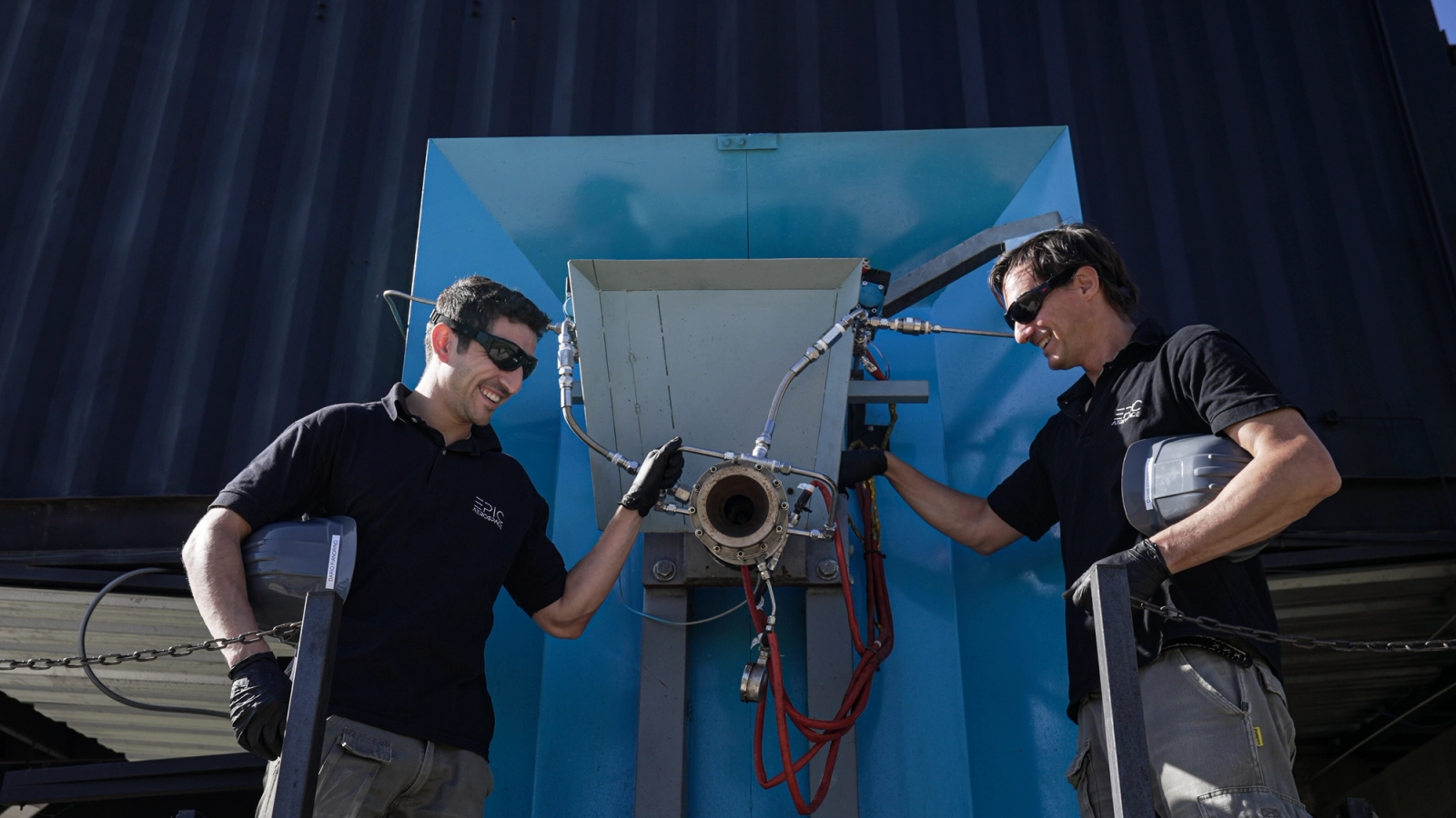 engineers working on an engine