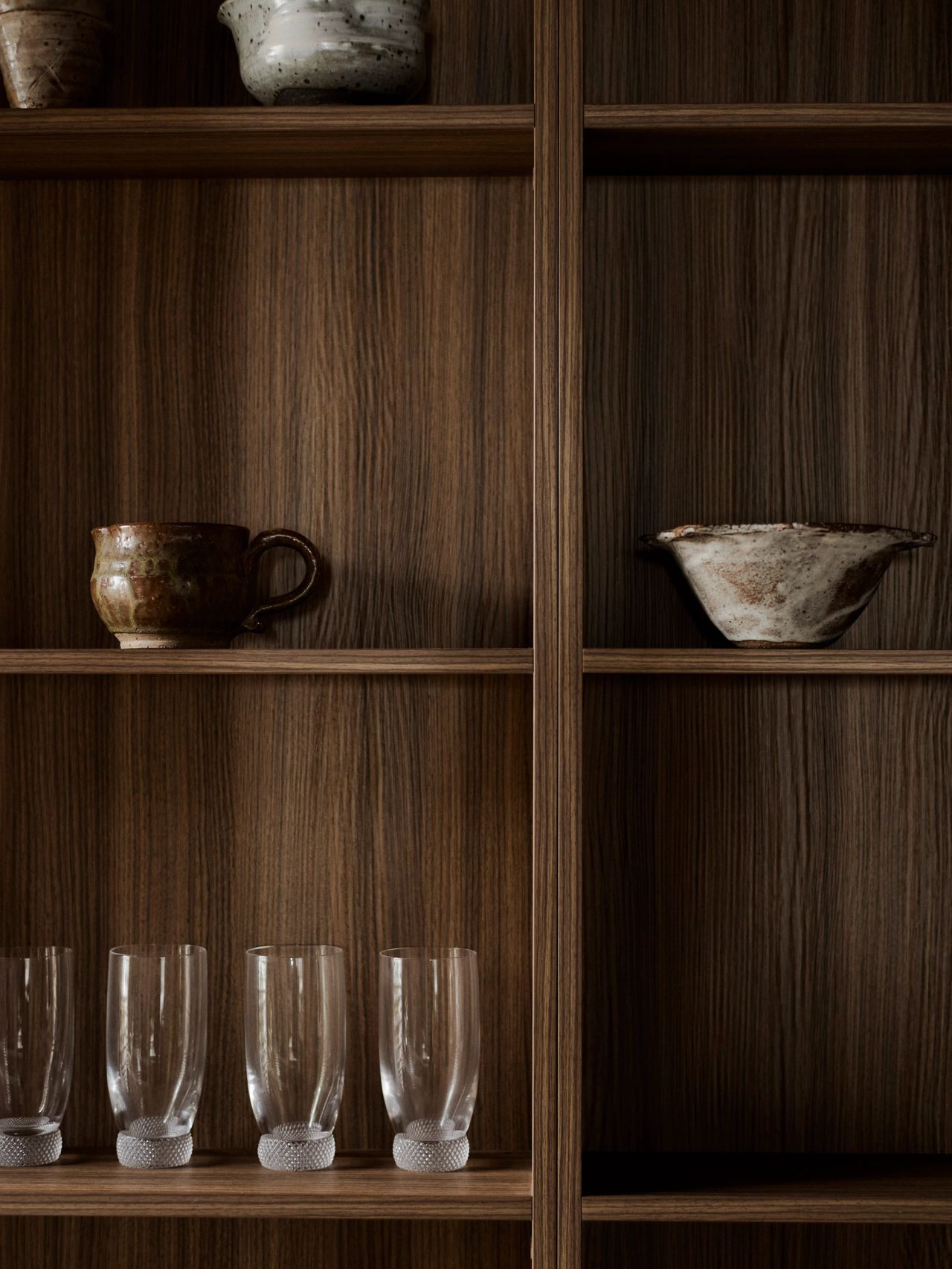 Orla contemporary Brazilian-influenced dark timber joinery shelving in butlers pantry with ceramics and glassware