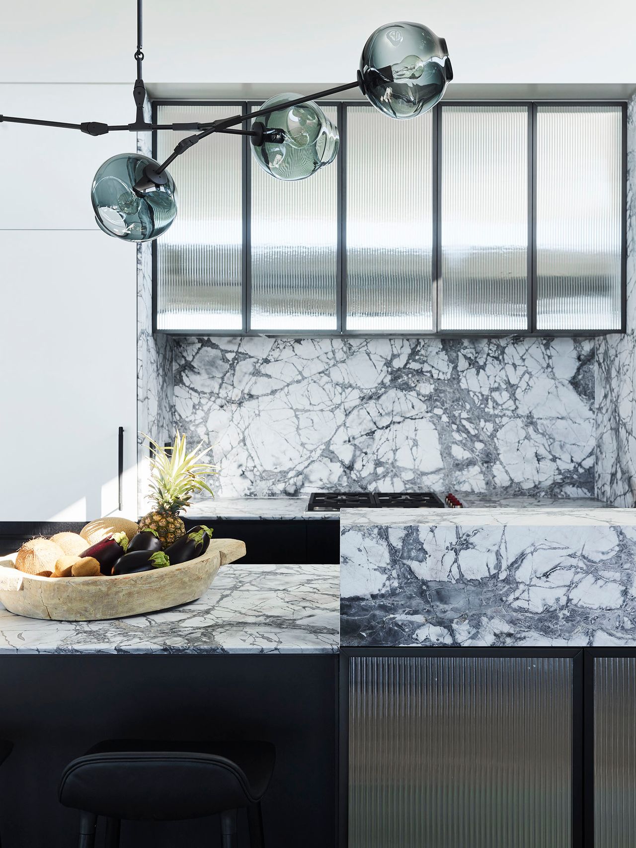 Killcare kitchen close up with white and grey veined marble counter top + splash bakc, black joinery 