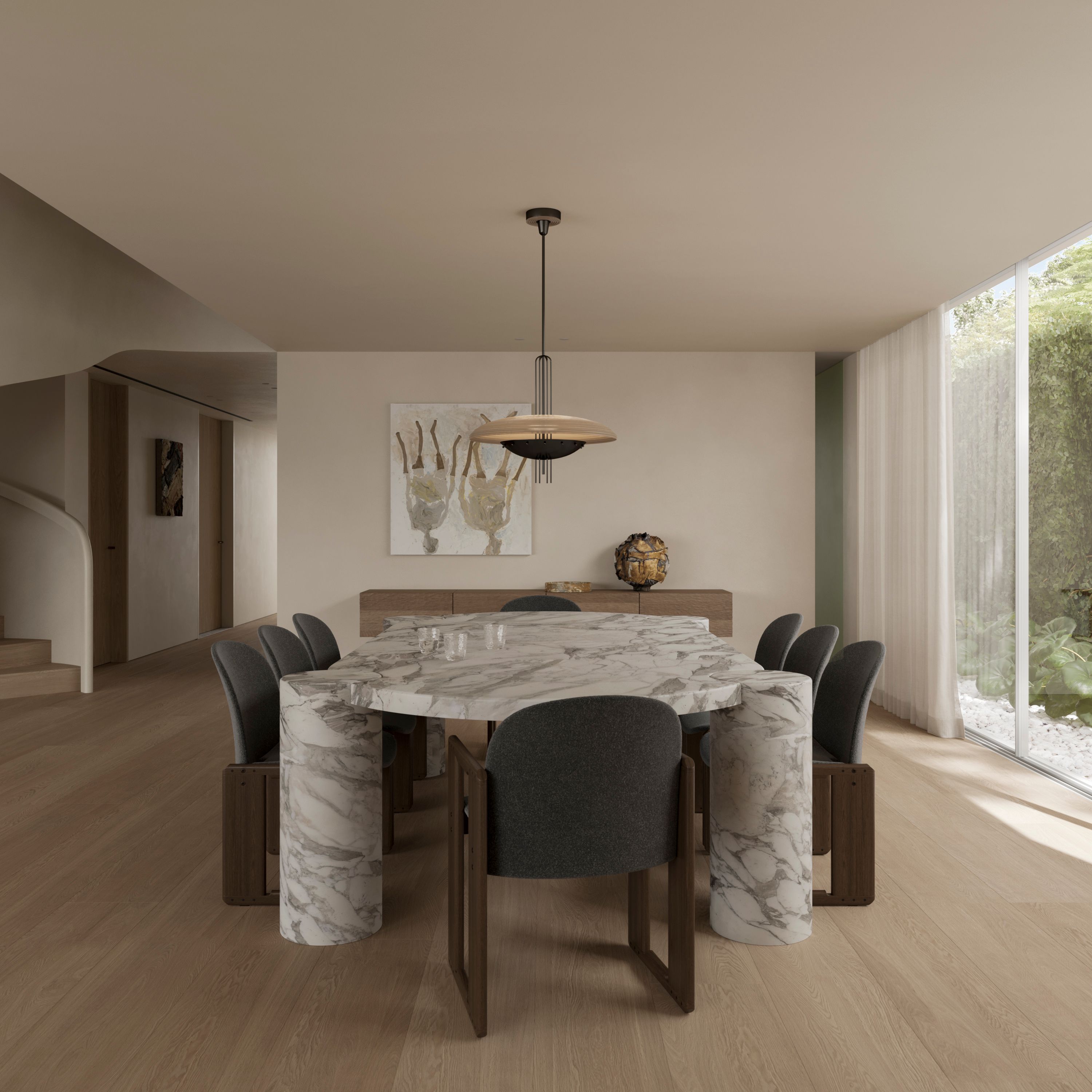 Park Dining room with a marble-clad octagonal table on cylindrical bases, dark upholstered chairs, a pendant light, and floor-to-ceiling windows overlooking greenery, with a curved staircase visible beyond.