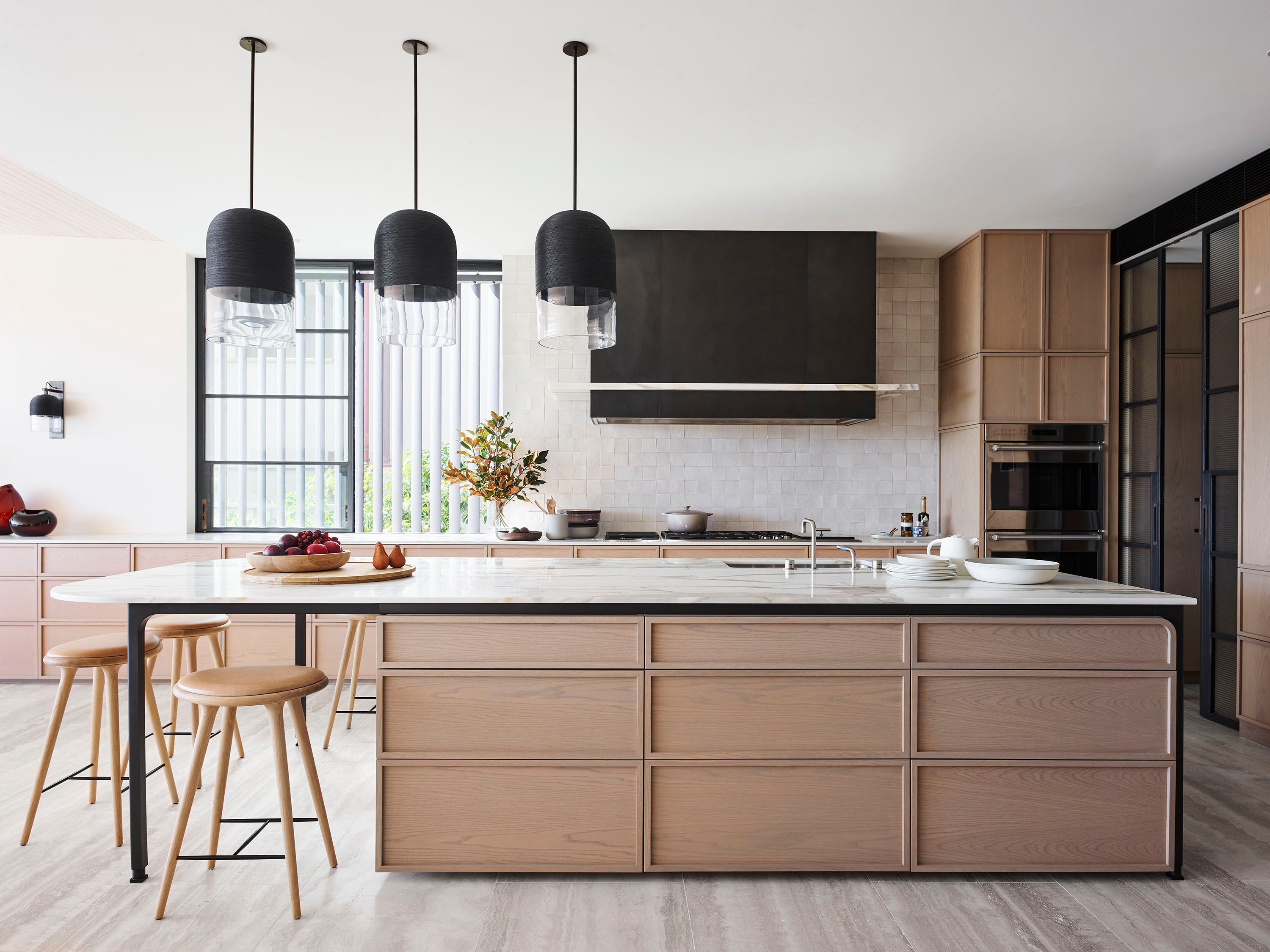 Hill House Kitchen light timber joinery with marble top and black pendants