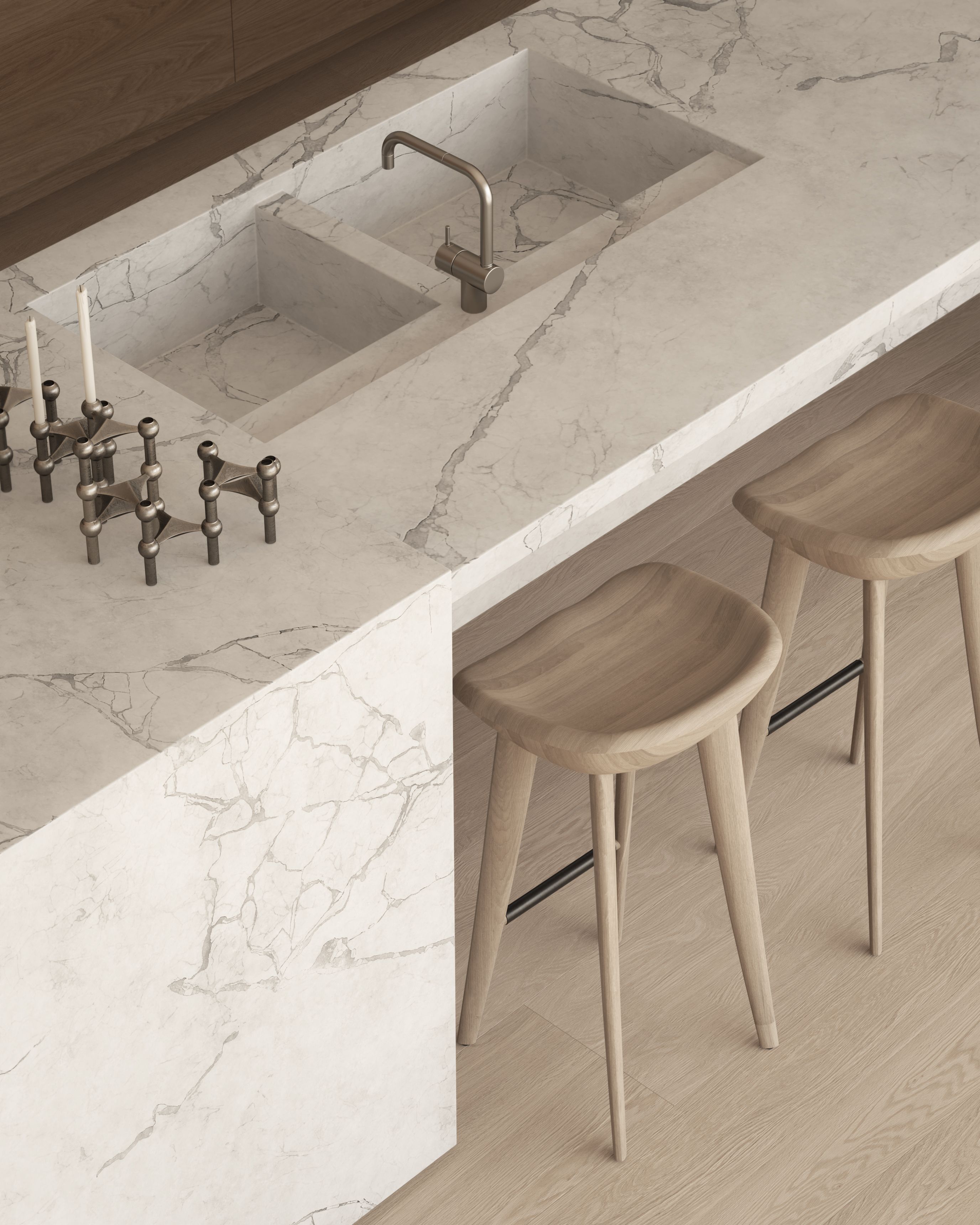 Contemporary kitchen with veined natural stone island and integrated double sink, brushed metal tapware, sculptural timber stools and light oak flooring.