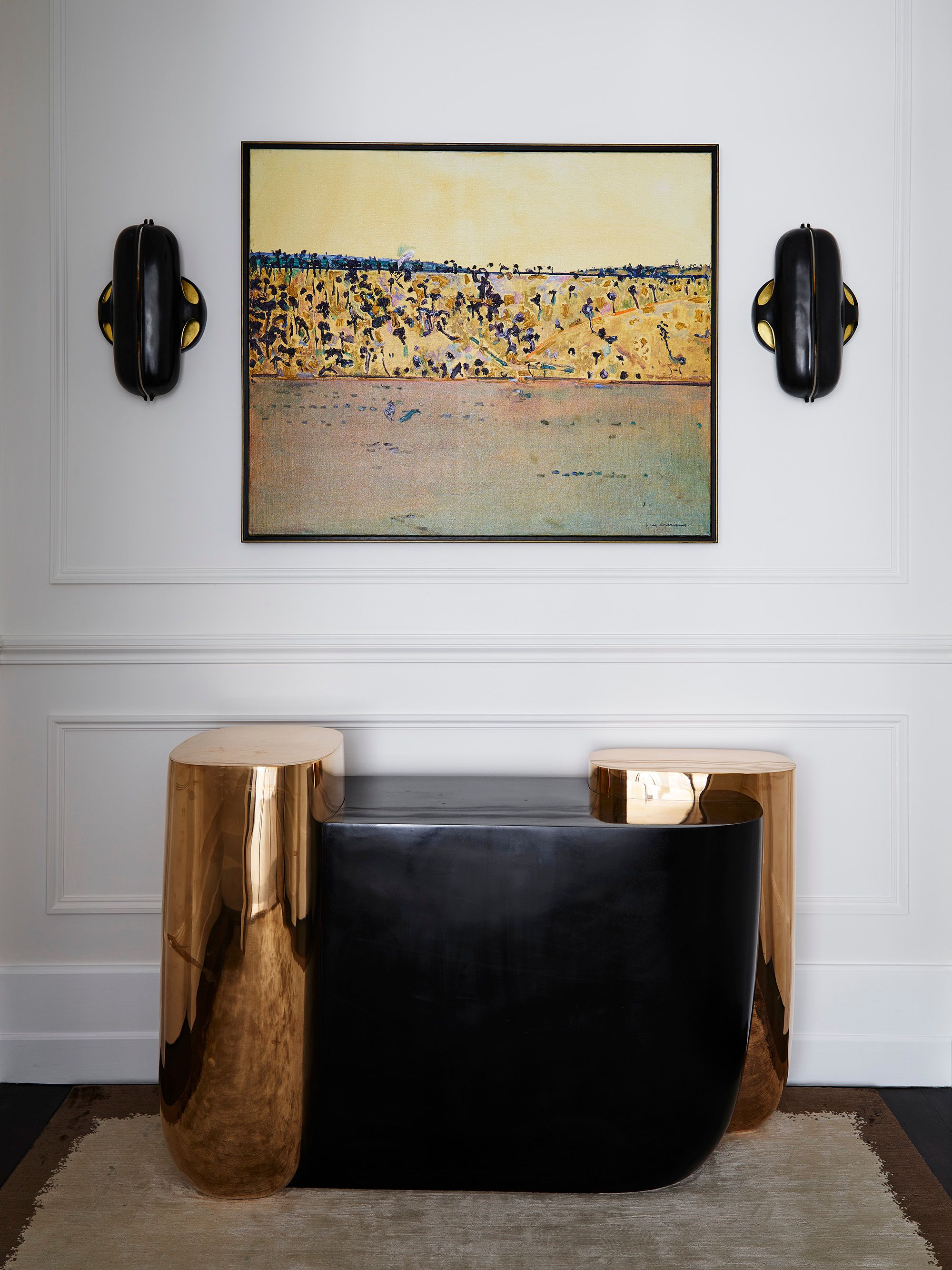 Heritage coastal home by Sydney interior design studio Decus, featuring a sculptural black and polished brass console, curated artwork and traditional wall panelling.