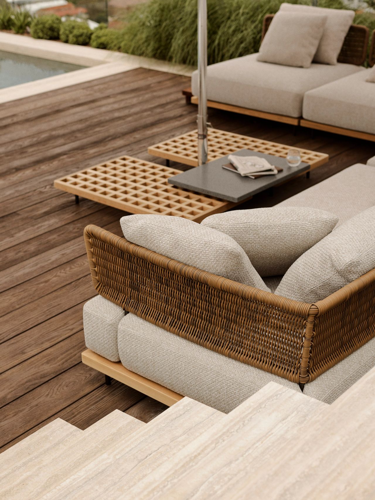 Orla outdoor timber terrace and pool view over the rolling hills of Sydney's eastern suburbs. Stone coloured ourdoor sofas and a cream coloured umbrella make a cozy outdoor lounge space - travertine flooring on stair treads leading up to the timber decking a level below with the pool